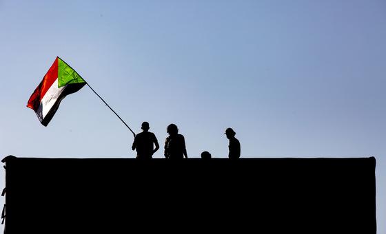 A Protester holding the Sudanese flag, in Khartoum, Sudan.