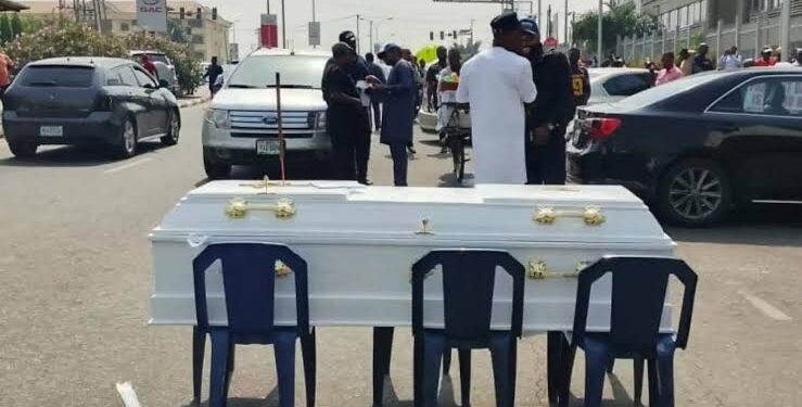 Angry Contractors Lay Coffin In Front Of Ministry Of Finance In Protest
